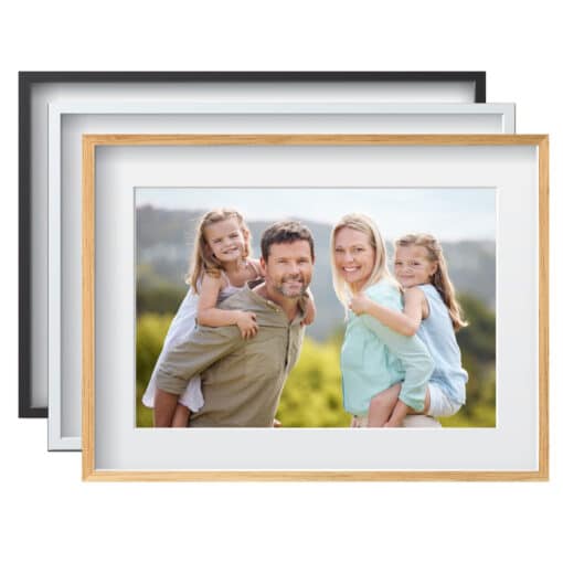 Framed family portrait with parents carrying children outdoors