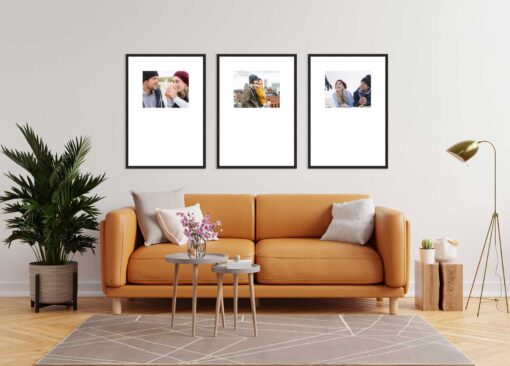 Living room with orange sofa and three framed photos on the wall.
