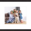 Framed family photo with parents, kids, and a dog.